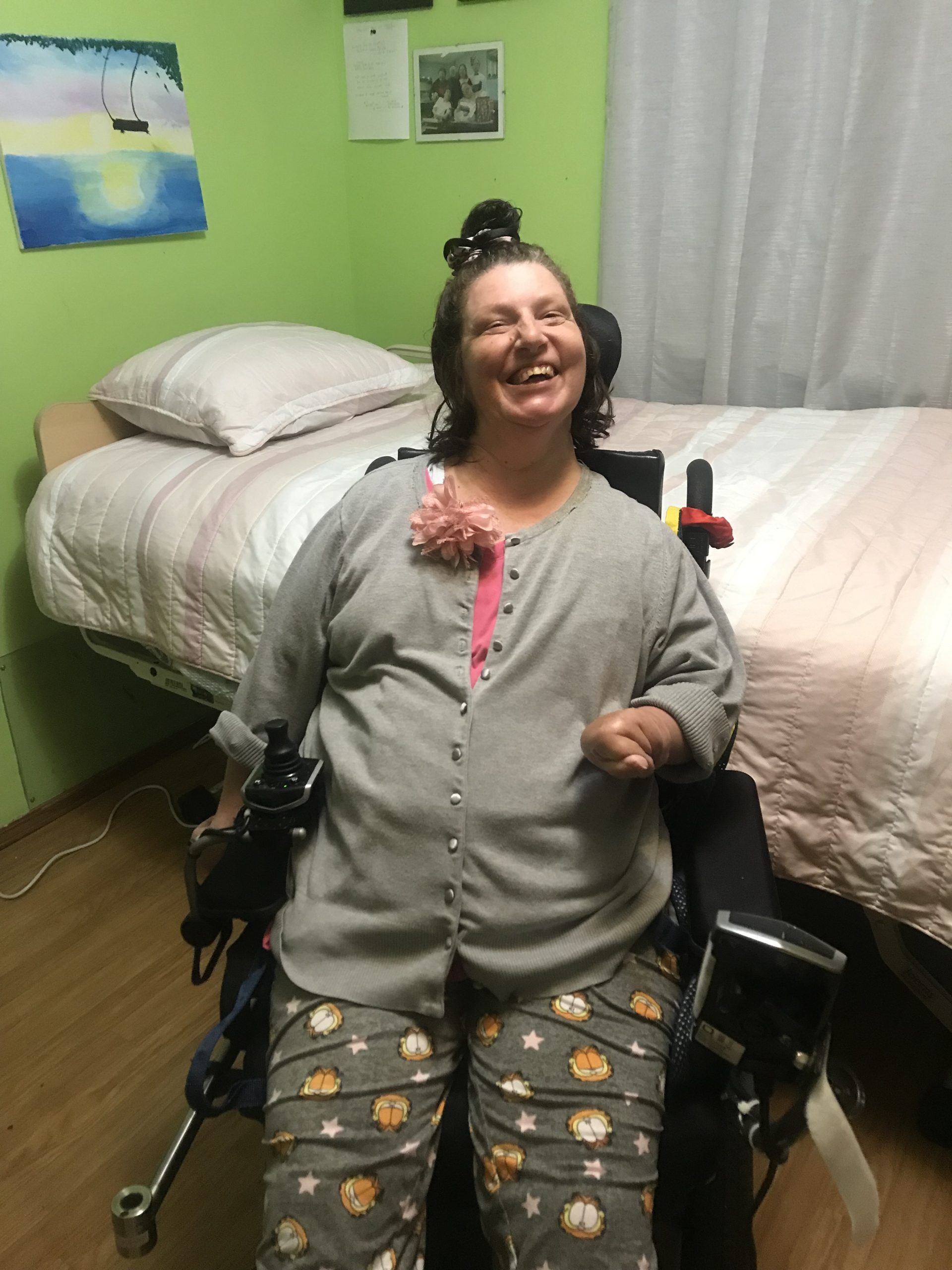 Woman in a wheelchair next to a comfort and safety bed